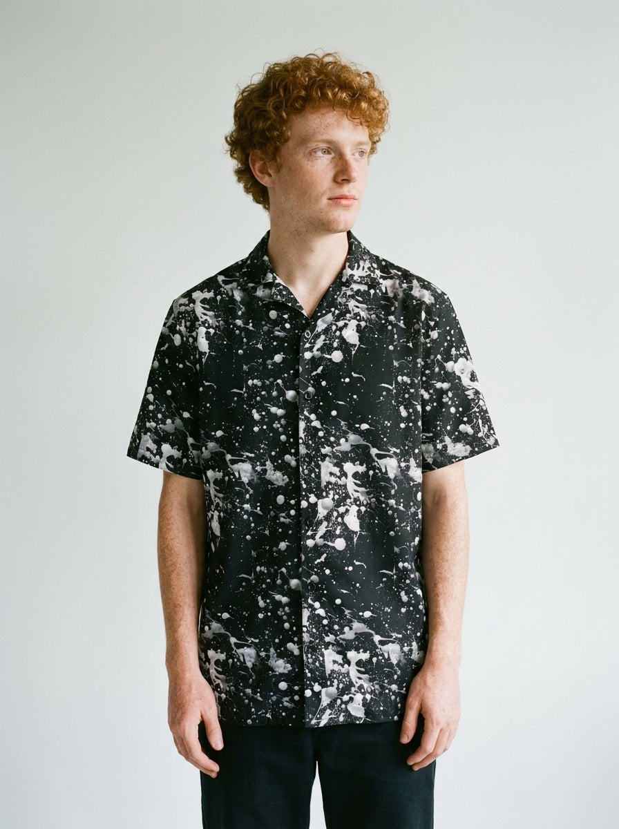 Model wearing the Black Paint splatter shirt by Design Hero, analog film photo