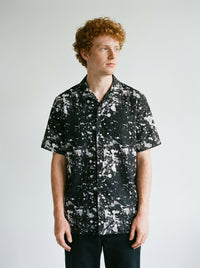 Model wearing the Black Paint splatter shirt by Design Hero, analog film photo