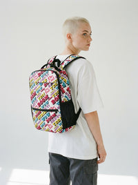 Model with platinum buzzcut wearing the Strike utility backpack by Design Hero, analog film photo