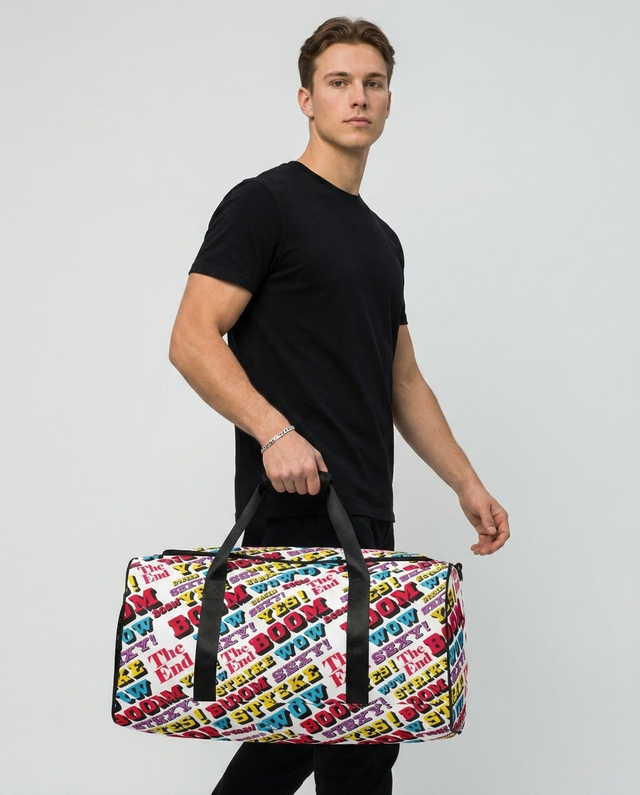 Man carrying the Strike duffle bag by Design Hero, comic pop art all-over print, studio photo