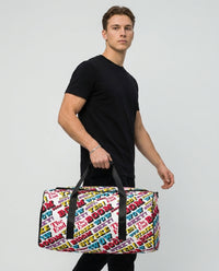 Man carrying the Strike duffle bag by Design Hero, comic pop art all-over print, studio photo