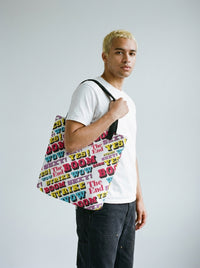 Model with bleached hair and septum piercing carrying the Strike all-over print tote bag by Design Hero, analog film photo